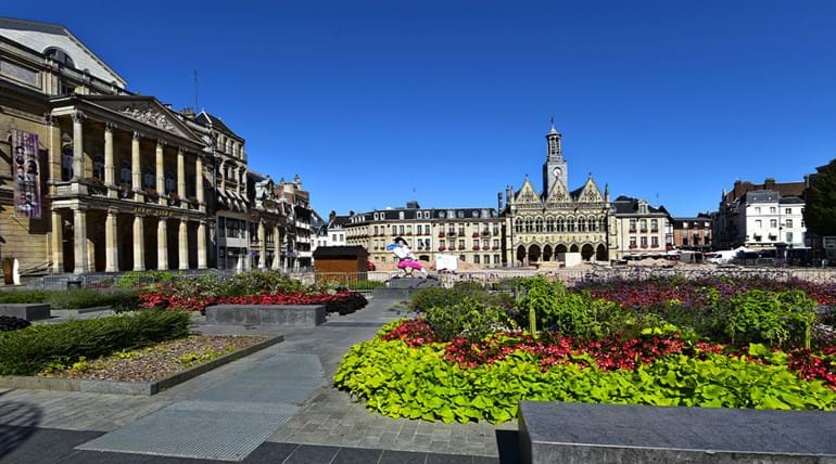 Town square surrounded by French architecture and garden in the foreground